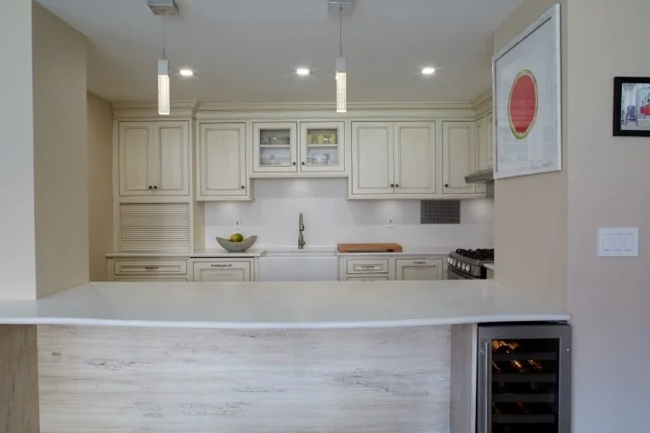 Spacious kitchen layout with shaker-style cabinetry, stainless steel range, and light wood flooring for a bright, airy city aesthetic.