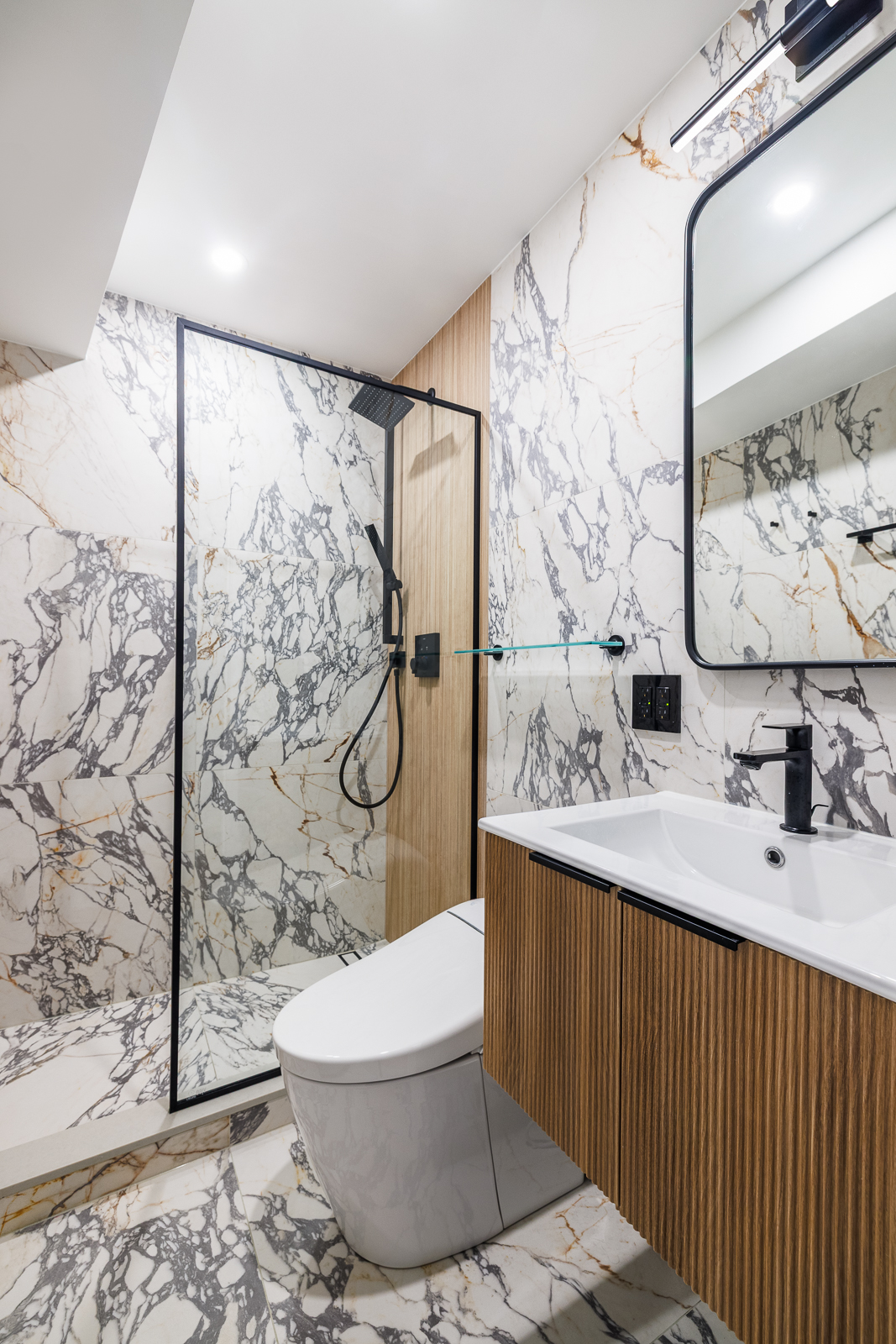Contemporary guest bathroom with wall-hung fluted vanity and TOTO smart toilet in NYC luxury renovation