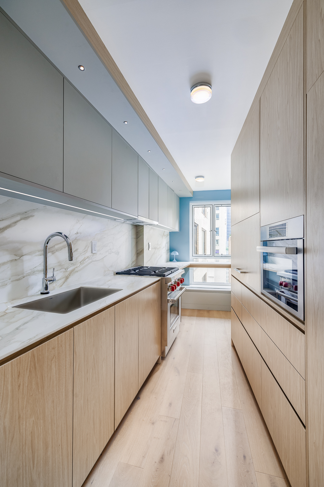 Modern NYC kitchen remodel with Miralis custom cabinets and Caesarstone countertops in Central Park South condo