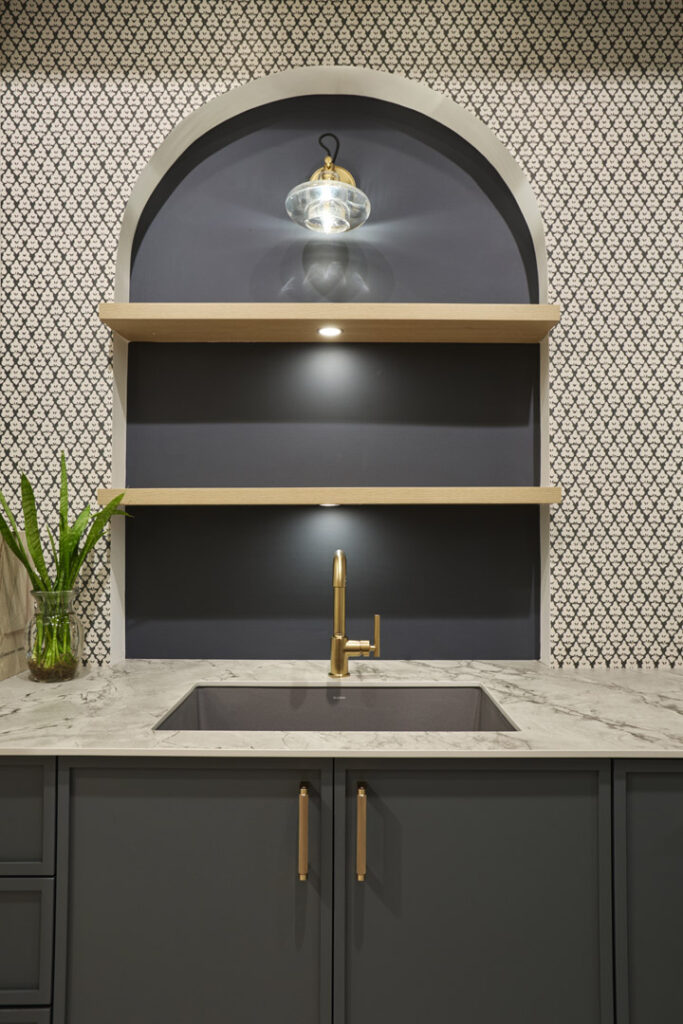 Wallpaper : Thibaut, Arboreta Cabinets : Miralis Door Style : Tribeca, Micro Shaker Door Color : Abaca Green Collection : Advanced Engineered, Fenix Handles : Top Knobs, Bar Pulls Countertop : Caesarstone, Porcelain Color name : 512 Transcenda Faucet : Kohler Purist Pull-Out Kitchen Faucet Sink : Blanco Precis 27 Silgranit Sink Lighting : Kohler Modern Farm Lacemaker Sconce
