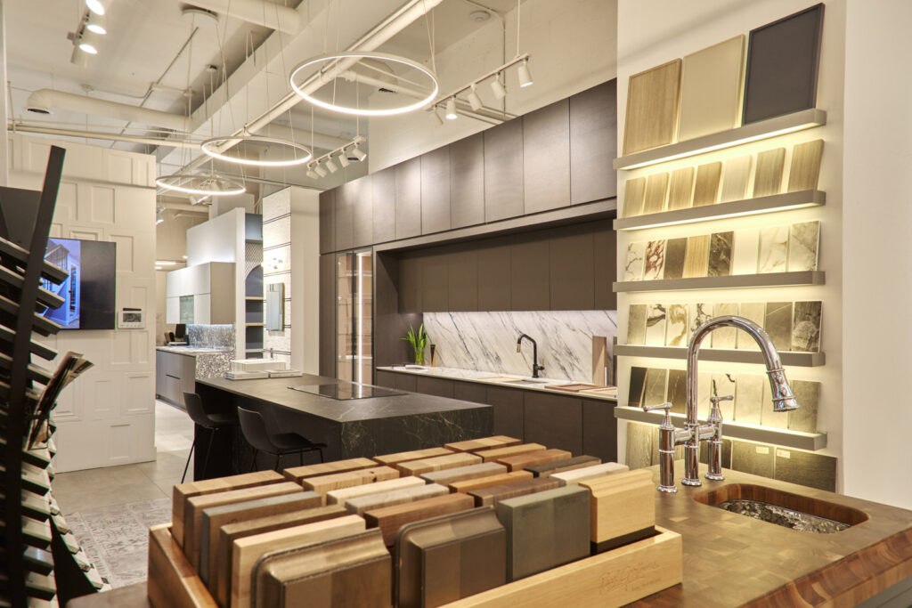 Cabinets : Miralis Door Style : Scott, Mitered Door Door Color : Abaca Green Collection : Wood Countertop : Dekton Color name : Trance Sink : Moen Lighting : Hafele