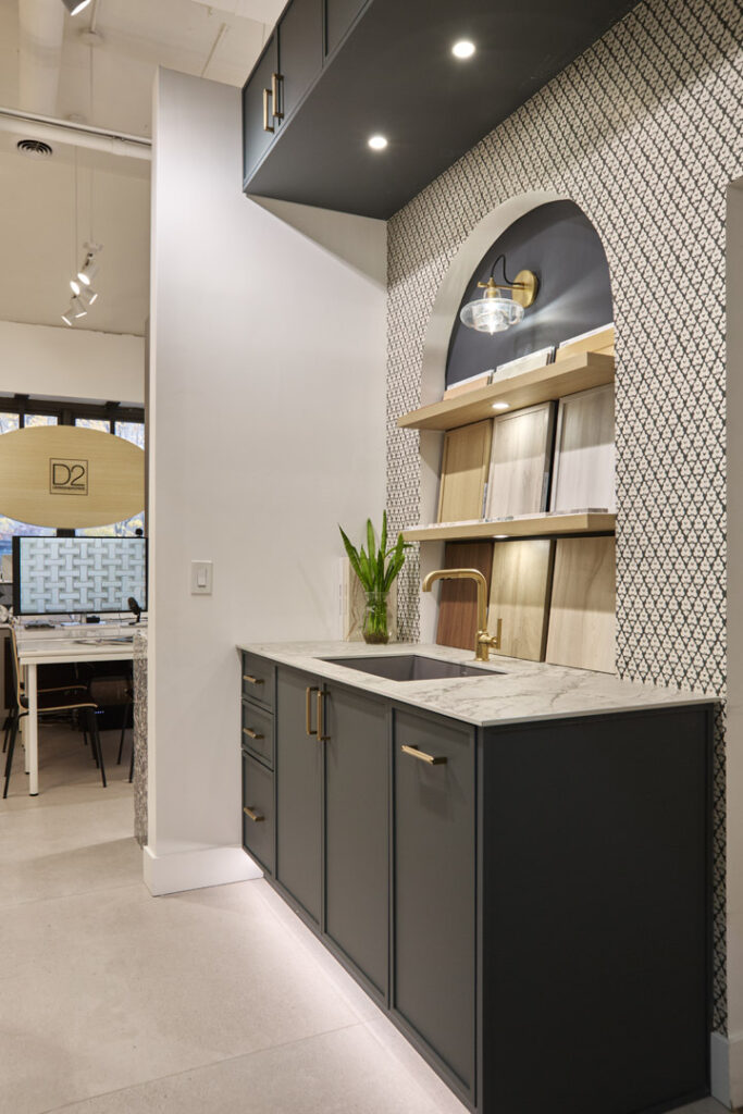 Wallpaper : Thibaut, Arboreta Cabinets : Miralis Door Style : Tribeca, Micro Shaker Door Color : Abaca Green Collection : Advanced Engineered, Fenix Handles : Top Knobs, Bar Pulls Countertop : Caesarstone, Porcelain Color name : 512 Transcenda Faucet : Kohler Purist Pull-Out Kitchen Faucet Sink : Blanco Precis 27 Silgranit Sink Lighting : Kohler Modern Farm Lacemaker Sconce